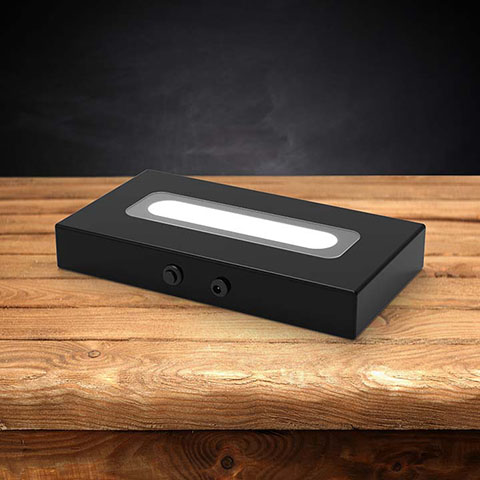 Wood LED light base with a dark background.