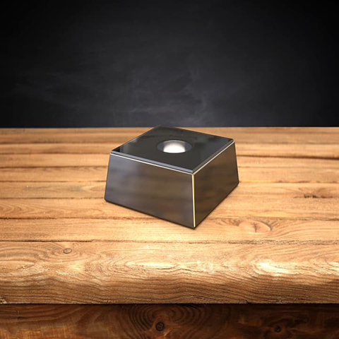 Square silver LED light base on a wooden table